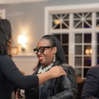 Woman putting her hand on another woman's shoulder